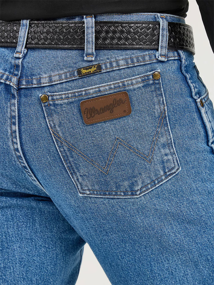 Wrangler 47MWZSW Mens Premium Performance Cowboy Cut Regular Fit Jean Stonewash front view. If you need any assistance with this item or the purchase of this item please call us at five six one seven four eight eight eight zero one Monday through Saturday 10:00a.m EST to 8:00 p.m EST