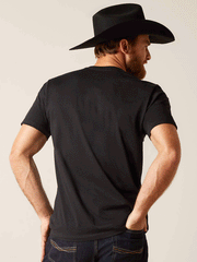 Ariat 10047839 Unisex Sendero Winking Skull T-Shirt Black back view on male model. If you need any assistance with this item or the purchase of this item please call us at five six one seven four eight eight eight zero one Monday through Saturday 10:00a.m EST to 8:00 p.m EST