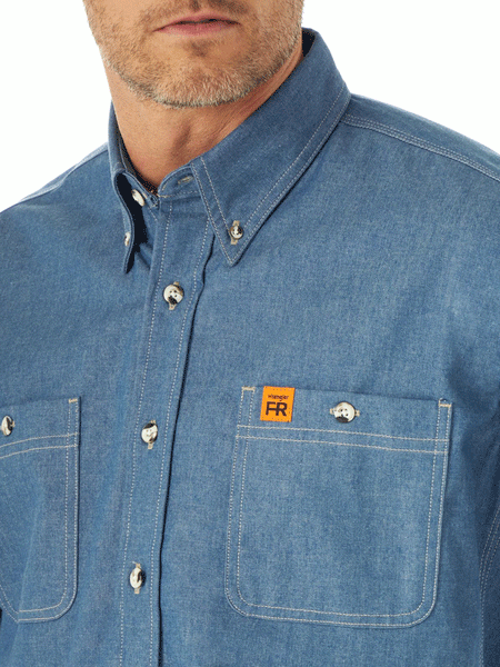 Wrangler FR3W01B Mens Flame Resistant Long Sleeve Work Shirt Blue Chambray front close up. If you need any assistance with this item or the purchase of this item please call us at five six one seven four eight eight eight zero one Monday through Saturday 10:00a.m EST to 8:00 p.m EST