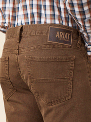 Ariat 10045230 Mens M7 Grizzly Straight Jean Peat Brown bacl pocket close up. If you need any assistance with this item or the purchase of this item please call us at five six one seven four eight eight eight zero one Monday through Saturday 10:00a.m EST to 8:00 p.m EST