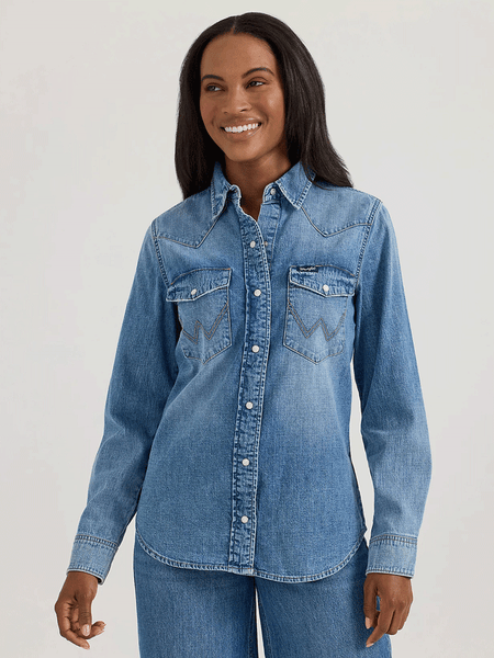 Wrangler 112360739 Womens Classic Denim Slim Western Snap Shirt Mid Wash front view. If you need any assistance with this item or the purchase of this item please call us at five six one seven four eight eight eight zero one Monday through Saturday 10:00a.m EST to 8:00 p.m EST