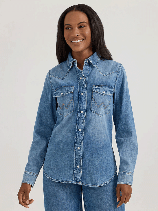 Wrangler 112360739 Womens Classic Denim Slim Western Snap Shirt Mid Wash front view. If you need any assistance with this item or the purchase of this item please call us at five six one seven four eight eight eight zero one Monday through Saturday 10:00a.m EST to 8:00 p.m EST