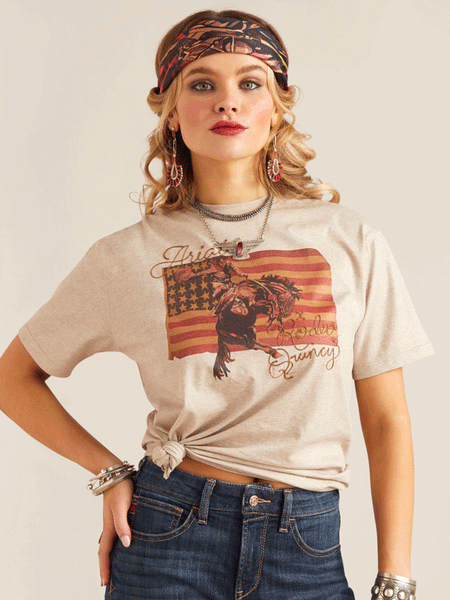Ariat 10048669 Womens Flag Rodeo Quincy T-Shirt Gold Tan front view. If you need any assistance with this item or the purchase of this item please call us at five six one seven four eight eight eight zero one Monday through Saturday 10:00a.m EST to 8:00 p.m EST