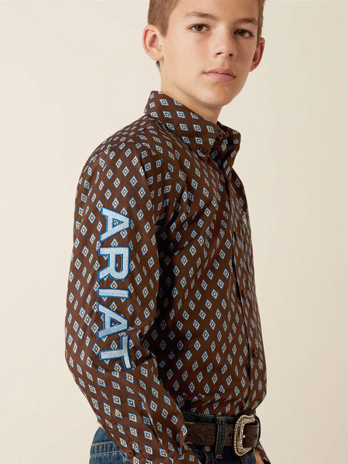 Ariat 10054069 Kids Team Oak Classic Fit Shirt Brownlight Blue front / view. If you need any assistance with this item or the purchase of this item please call us at five six one seven four eight eight eight zero one Monday through Saturday 10:00a.m EST to 8:00 p.m EST