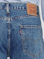 Levi’s 005054891 Mens 505 Regular Fit Jeans Medium Stonewash back pocket close up. If you need any assistance with this item or the purchase of this item please call us at five six one seven four eight eight eight zero one Monday through Saturday 10:00a.m EST to 8:00 p.m EST