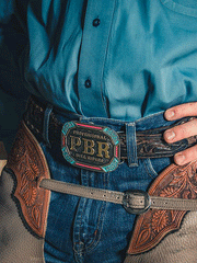 Montana Silversmiths PBR939 PBR Vibrant Riders Belt Buckle fron view on model. If you need any assistance with this item or the purchase of this item please call us at five six one seven four eight eight eight zero one Monday through Saturday 10:00a.m EST to 8:00 p.m EST