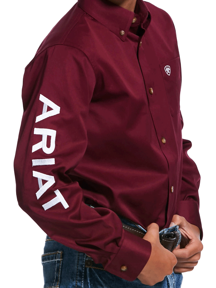 Ariat 10030163 Kids Team Logo Twill Classic Fit Shirt Burgundy front and side view. If you need any assistance with this item or the purchase of this item please call us at five six one seven four eight eight eight zero one Monday through Saturday 10:00a.m EST to 8:00 p.m EST