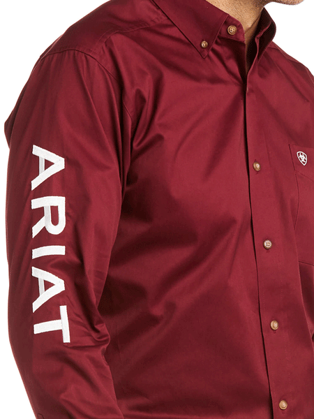 Ariat 10034233 Mens Team Logo Twill Fitted Shirt Burgundy sleeve close up. If you need any assistance with this item or the purchase of this item please call us at five six one seven four eight eight eight zero one Monday through Saturday 10:00a.m EST to 8:00 p.m EST