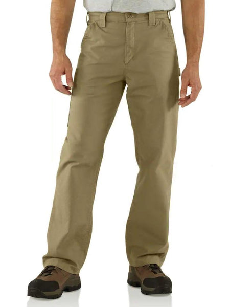 Carhartt B151 Mens Canvas Work Dungaree Pants Dark Khaki front view on model. If you need any assistance with this item or the purchase of this item please call us at five six one seven four eight eight eight zero one Monday through Saturday 10:00a.m EST to 8:00 p.m EST