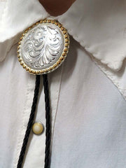 Rockmount 43819 Engraved Gold Trim Concho Bolo Tie Silver close up. If you need any assistance with this item or the purchase of this item please call us at five six one seven four eight eight eight zero one Monday through Saturday 10:00a.m EST to 8:00 p.m EST