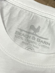 Beach & Barn EMBLEM-LS-WHT Mens Emblem Long Sleeve Tee White tag close up. If you need any assistance with this item or the purchase of this item please call us at five six one seven four eight eight eight zero one Monday through Saturday 10:00a.m EST to 8:00 p.m EST