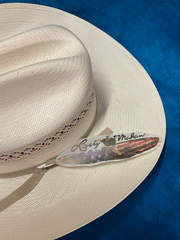 Larry Mahan MSUS42OLDX 10X OLD GLORY Straw Hat Ivory feather close up. If you need any assistance with this item or the purchase of this item please call us at five six one seven four eight eight eight zero one Monday through Saturday 10:00a.m EST to 8:00 p.m EST