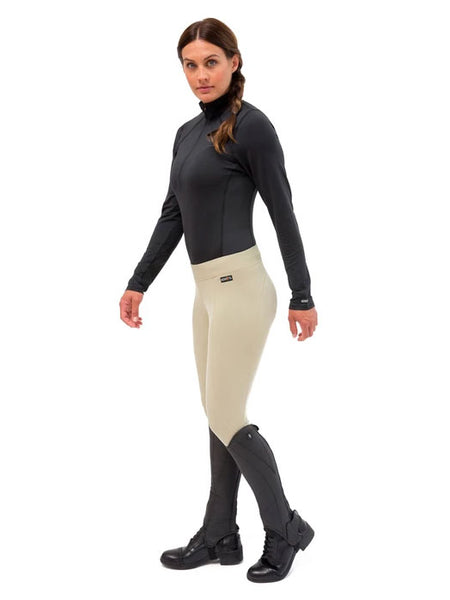 Kerrits 50200 Womens Flow Rise Knee Patch Performance Tight tan view on model dressed for riding. If you need any assistance with this item or the purchase of this item please call us at five six one seven four eight eight eight zero one Monday through Saturday 10:00a.m EST to 8:00 p.m EST