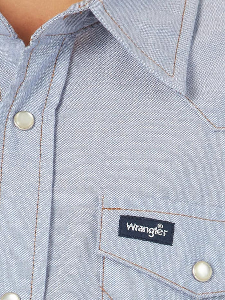 Wrangler BW7013B Boy's Cowboy Cut Western Snap Shirt Blue Chambray close up pocket. If you need any assistance with this item or the purchase of this item please call us at five six one seven four eight eight eight zero one Monday through Saturday 10:00a.m EST to 8:00 p.m EST