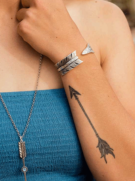 Montana Silversmiths BC4885 Womens Timber Ridge Arrow Cuff Bracelet Silver on model. If you need any assistance with this item or the purchase of this item please call us at five six one seven four eight eight eight zero one Monday through Saturday 10:00a.m EST to 8:00 p.m EST