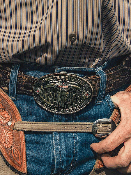 Montana Silversmiths PBR941 PBR Open Flames Belt Buckle front view on model. If you need any assistance with this item or the purchase of this item please call us at five six one seven four eight eight eight zero one Monday through Saturday 10:00a.m EST to 8:00 p.m EST