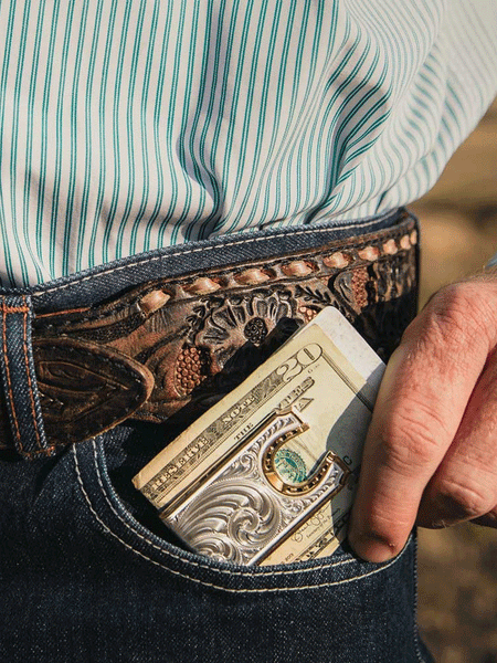 Montana Silversmiths MCL5236 Two-Tone Carved Horseshoe Money Clip Silver on model. If you need any assistance with this item or the purchase of this item please call us at five six one seven four eight eight eight zero one Monday through Saturday 10:00a.m EST to 8:00 p.m EST