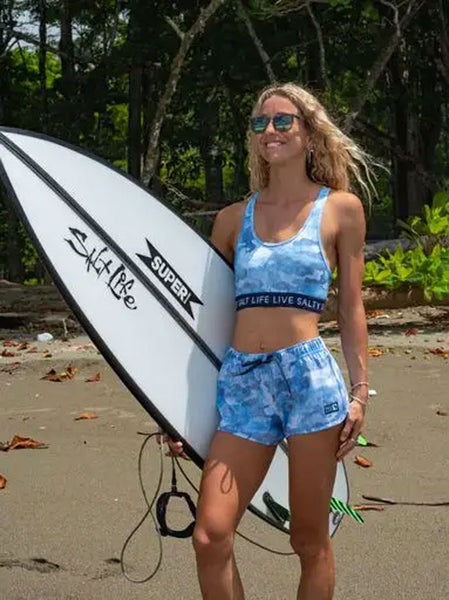 Salt Life SLJ6056 Womens Into the Abyss Sports Bra Blue on model. If you need any assistance with this item or the purchase of this item please call us at five six one seven four eight eight eight zero one Monday through Saturday 10:00a.m EST to 8:00 p.m EST