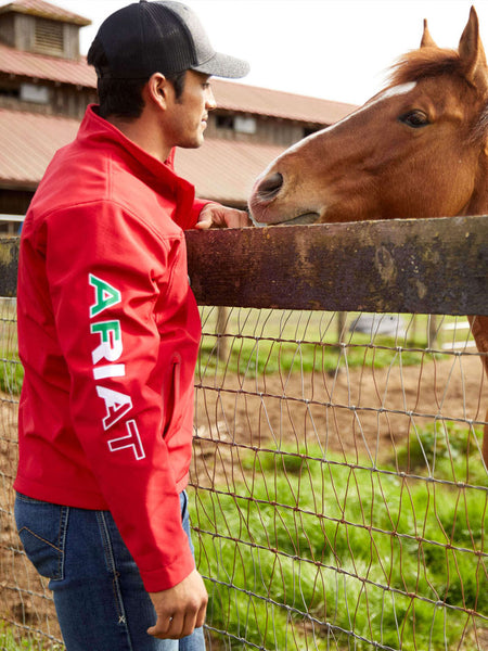 Ariat 10033525 Mens New Team Softshell MEXICO Jacket Red side view. If you need any assistance with this item or the purchase of this item please call us at five six one seven four eight eight eight zero one Monday through Saturday 10:00a.m EST to 8:00 p.m EST