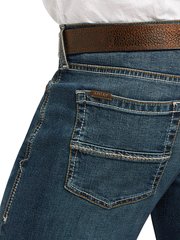 Ariat 10039625 Mens M8 Modern TekStretch Sebastian Slim Leg Jean Grafton back pocket close up. If you need any assistance with this item or the purchase of this item please call us at five six one seven four eight eight eight zero one Monday through Saturday 10:00a.m EST to 8:00 p.m EST