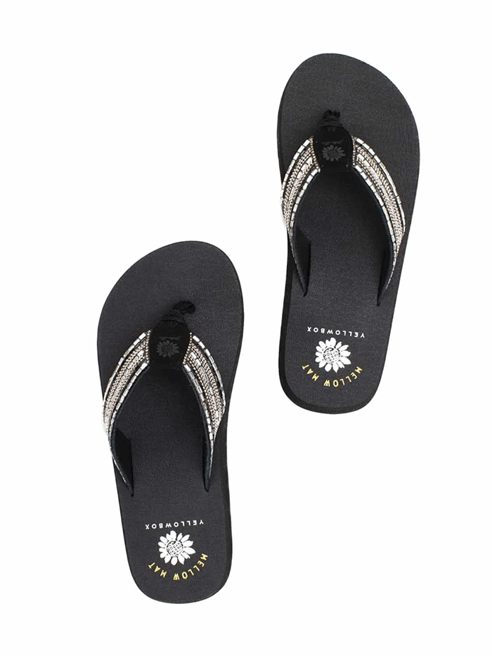 Yellow Box 52679 Womens Nazene Flip Flop Sandals Black side and front view. If you need any assistance with this item or the purchase of this item please call us at five six one seven four eight eight eight zero one Monday through Saturday 10:00a.m EST to 8:00 p.m EST