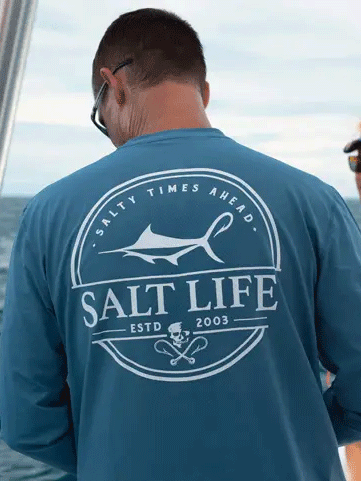 Salt Life SLM6242 Mens Dragnet Long Sleeve Performance Tee Coastal Blue back view on model. If you need any assistance with this item or the purchase of this item please call us at five six one seven four eight eight eight zero one Monday through Saturday 10:00a.m EST to 8:00 p.m EST