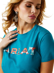 Ariat 10043632 Womens REAL Boot Kickin' Logo Tee Exotic Plume front design close up. If you need any assistance with this item or the purchase of this item please call us at five six one seven four eight eight eight zero one Monday through Saturday 10:00a.m EST to 8:00 p.m EST